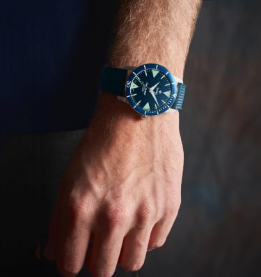 The Super Sea Wolf Skin Diver watch with a blue sunray dial and shark tooth markers shown on a wrist