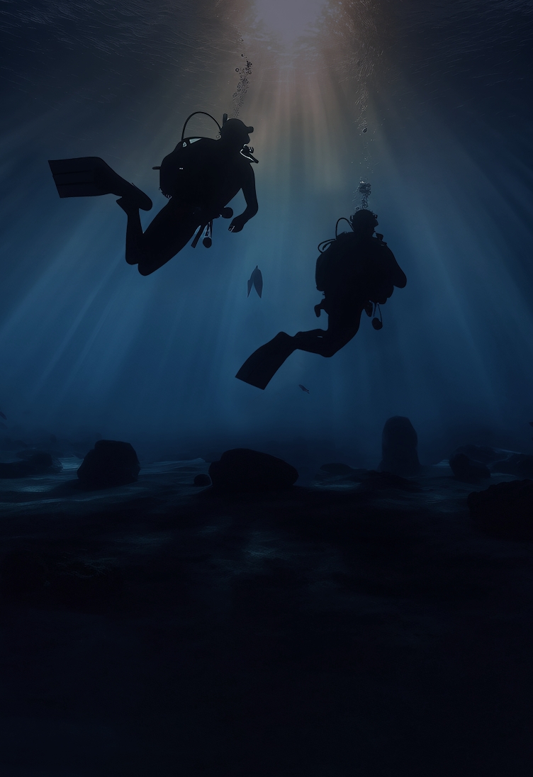 A scuba diver swimming in dark blue ocean waters.