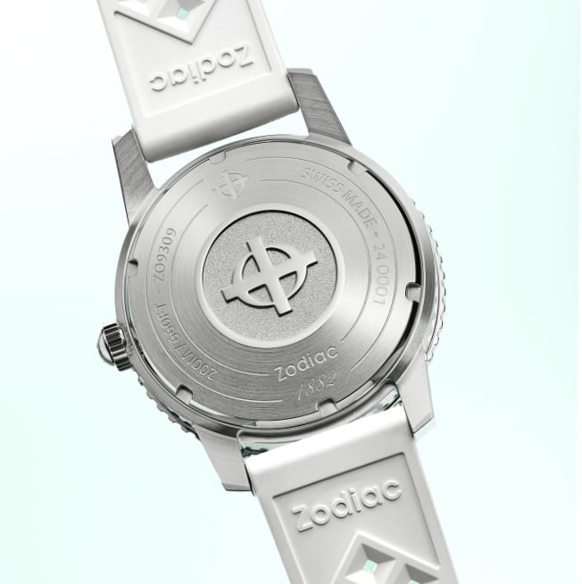 Detail shot of the Super Sea Wolf Compression Diver caseback featuring the Zodiac crosshair logo with the logo-embossed white tropic rubber strap