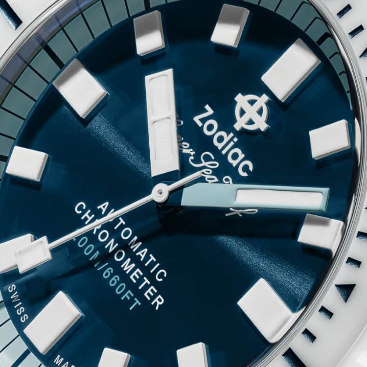 Close up of a Super Sea Wolf Compression watch with a white ceramic bezel and sea blue dial