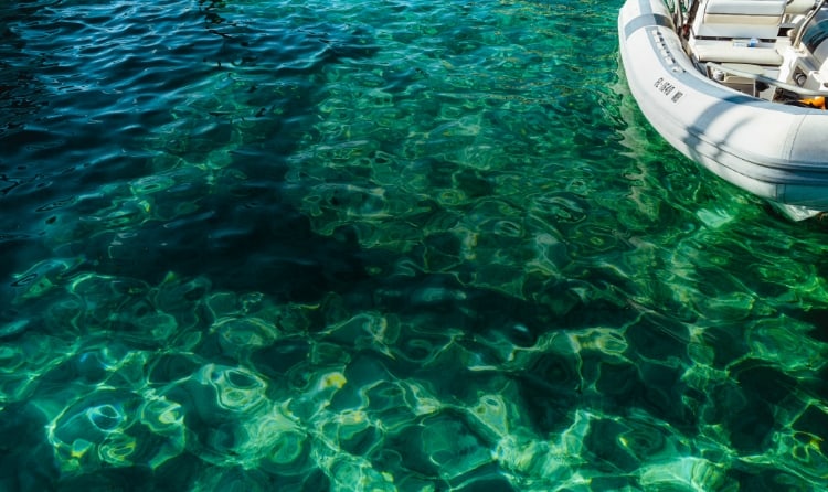 Ocean water with a white boat.