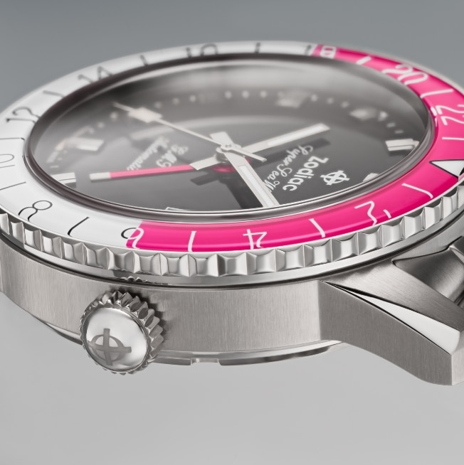 Close up shot of a Super Sea Wolf GMT watch with a pink and white, split rotating bezel