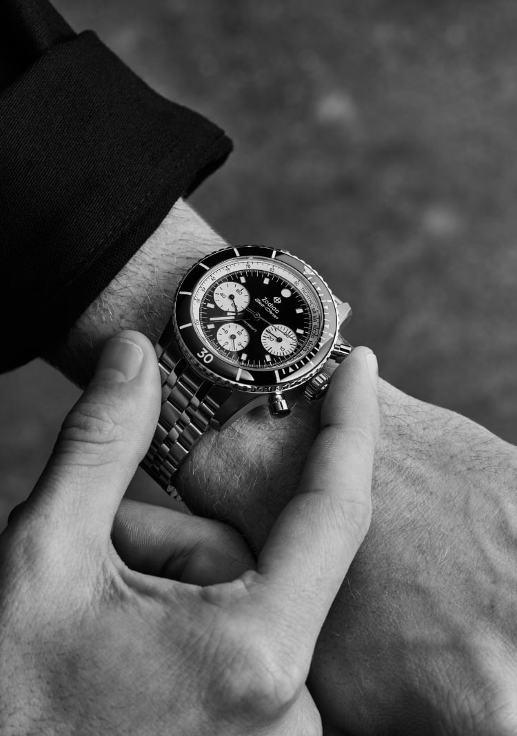 Man holding Zodiac watches.