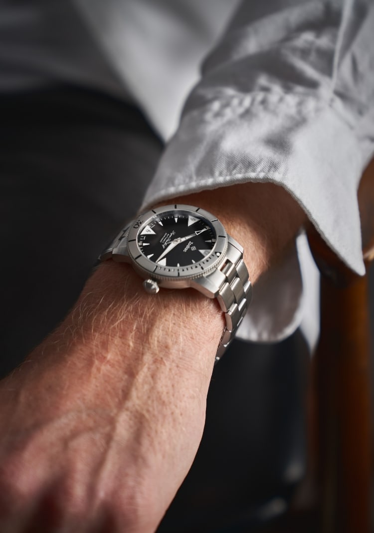Man holding Zodiac watches.