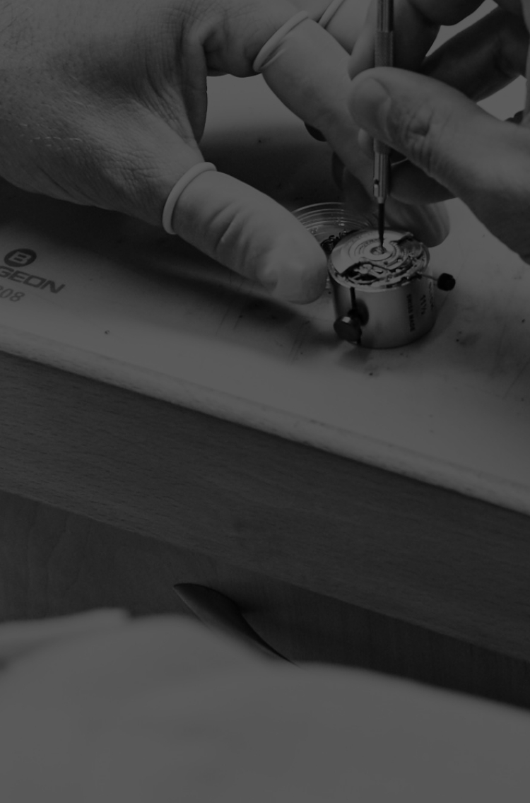 Watch craftsman assembling a watch.