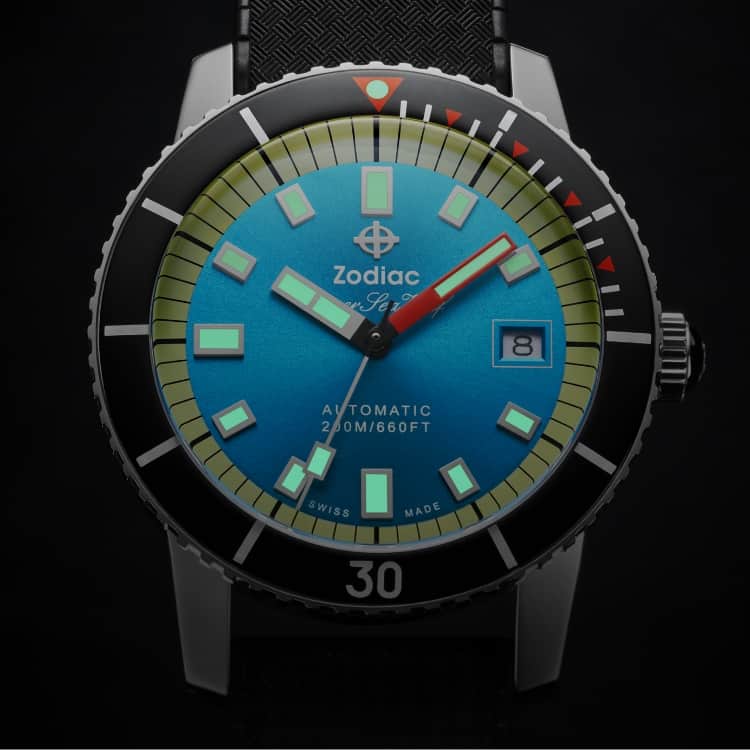 Detail shot of a Super Sea Wolf Compression Diver watch with a black bezel, blue sunray dial, and glowing Super-LumiNova® hands and markers
