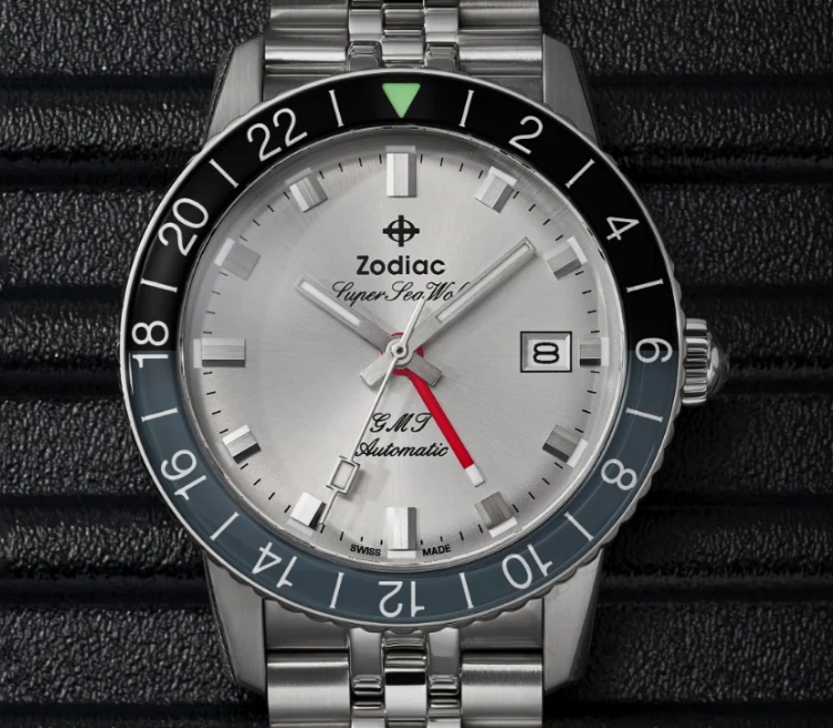 Close up shot of a Super Sea Wolf GMT watch with focus on the gray and black rotating bezel and red fourth hand