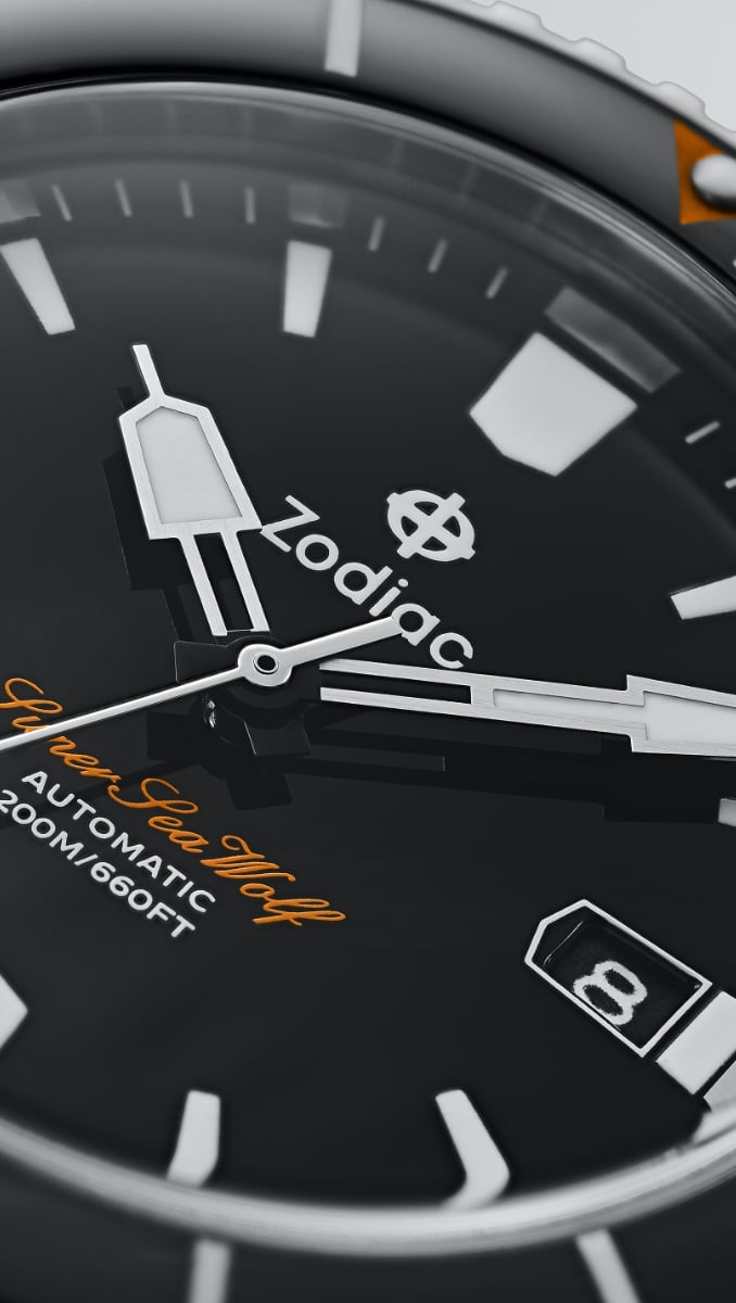 A close up of the watch's hands, indices, date window and black dial. A close up of the watch's hands, indices, date window and black dial.
